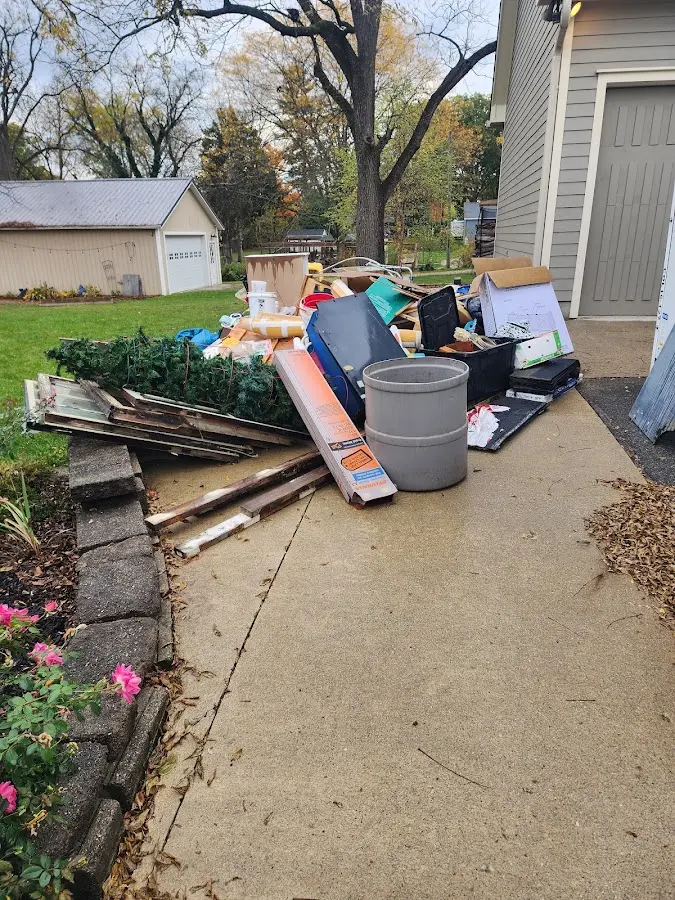 Dumpster being loaded with debris for Roofing Dumpster Rental in Wrightsboro